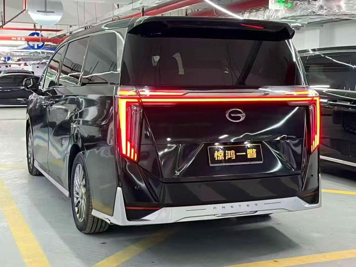 Luxury MPV, rear view with lit tail lights